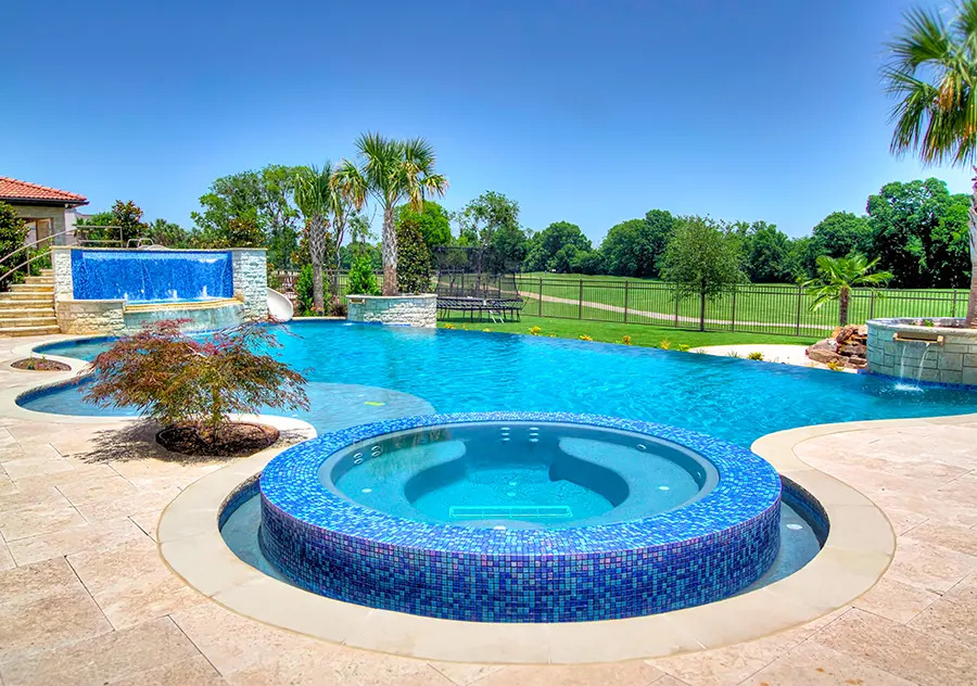 Freeform pool with water features.