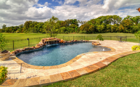 Freeform pool with fire pit.